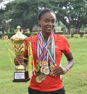 Naomi Adeoyin displaying her trophy and some of themedals she won at tournaments.
