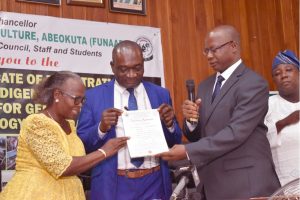 The Vice-Chancellor, Professor Kolawole Salako (middle), ably assisted by the Principal Researcher, Professor Olufunmilayo Adebambo (left) receiving Certificate of Registration from the CEO of NACGRAG and Registrar NVRC, Dr. S. E. Aladele at the historic occasion