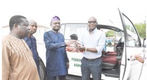 Director DUFARMS, Mr Joseph Olabasola receiving the keys of the SUV from the Vice Chancellor