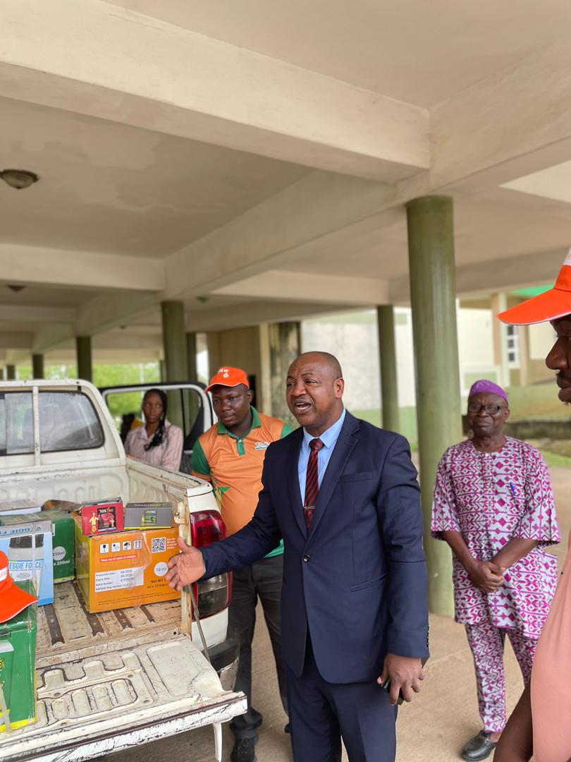 Representative of the Vice-Chancellor and the Deputy Vice-Chancellor, Development, Prof. Olawale Dairo receiving the donated seeds from Jubaili Agrotec