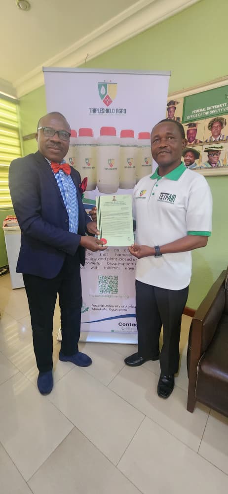 Representative of the Vice-Chancellor and the Deputy Vice-Chancellor, Academic, Prof. Olusegun Idowu (Left), receiving the Patent Certificate from the Team Lead, Prof. Akinola Popoola